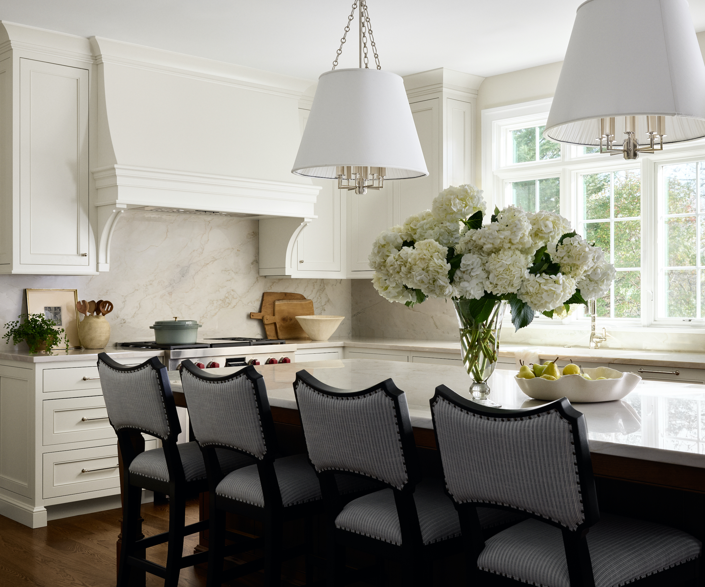 white kitchen with four bar stools