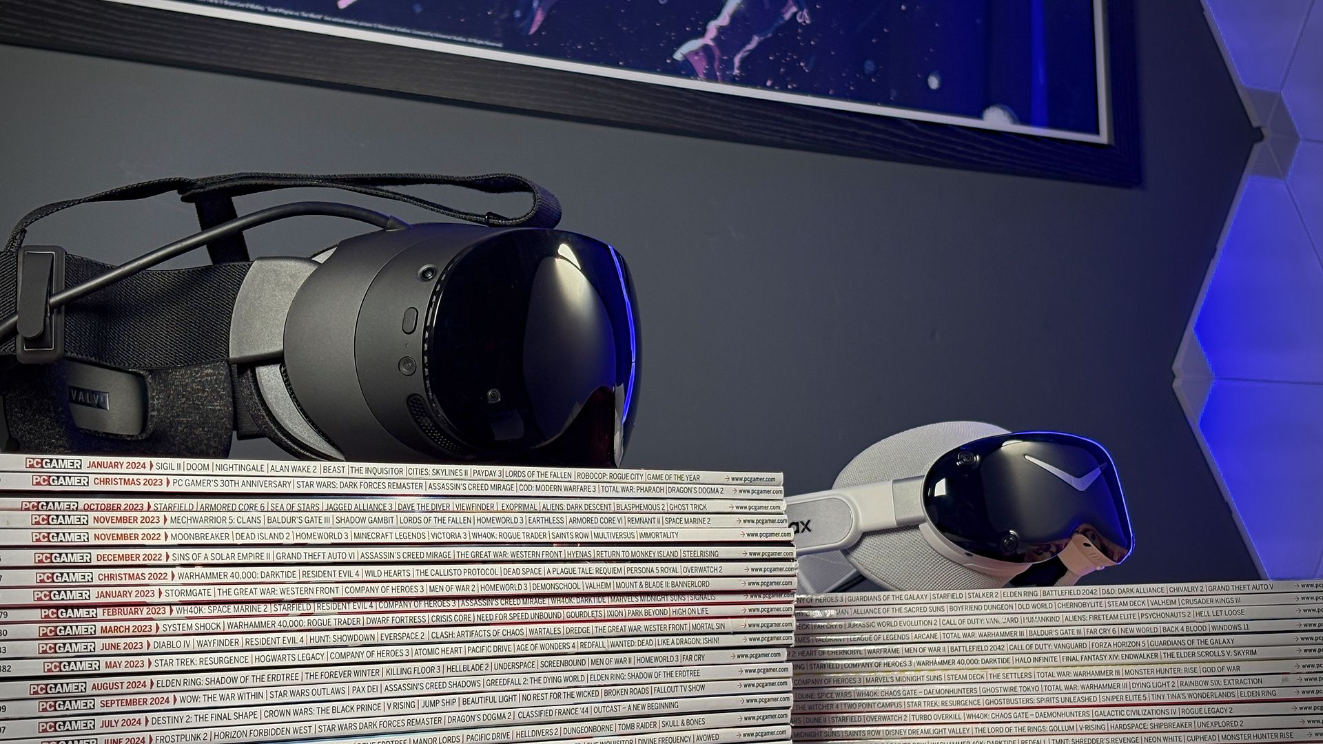 The Steam Frame in front of the Pimax Dream Air on a stack of PC Gamer magazines.