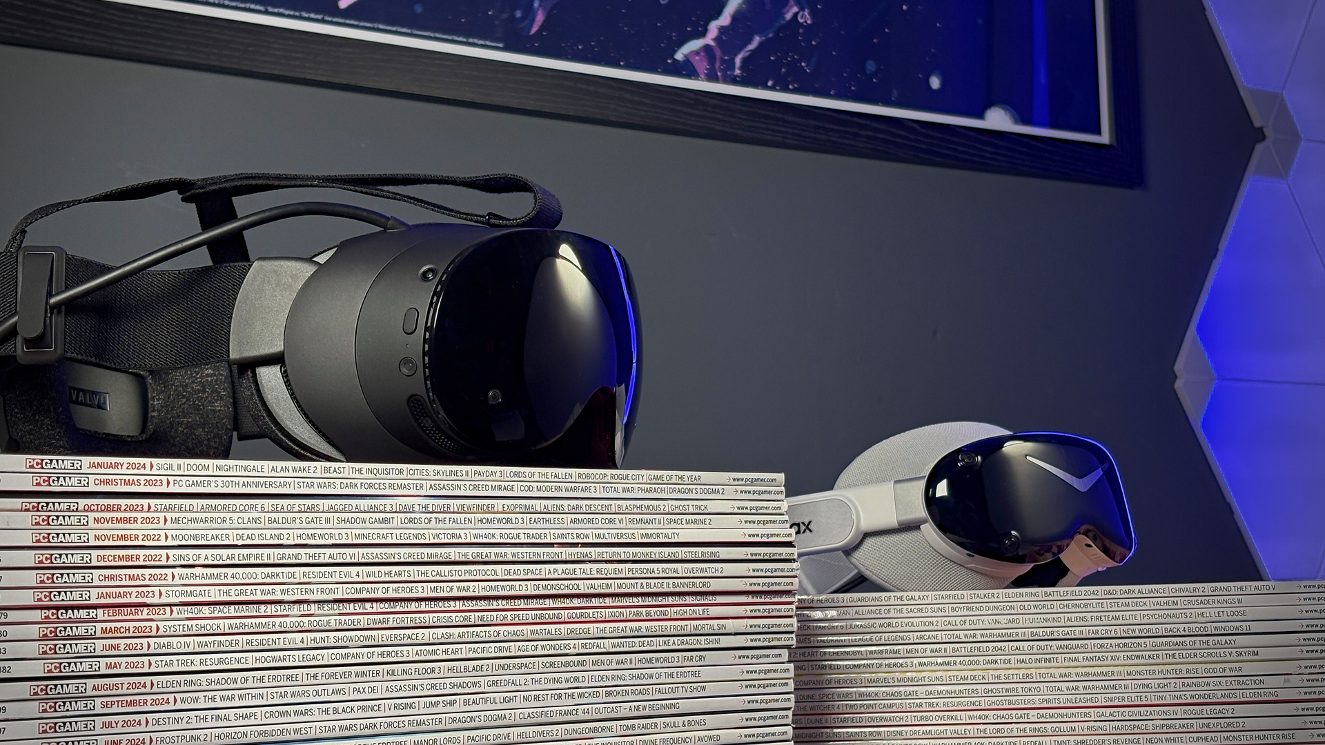 The Steam Frame in front of the Pimax Dream Air on a stack of PC Gamer magazines.