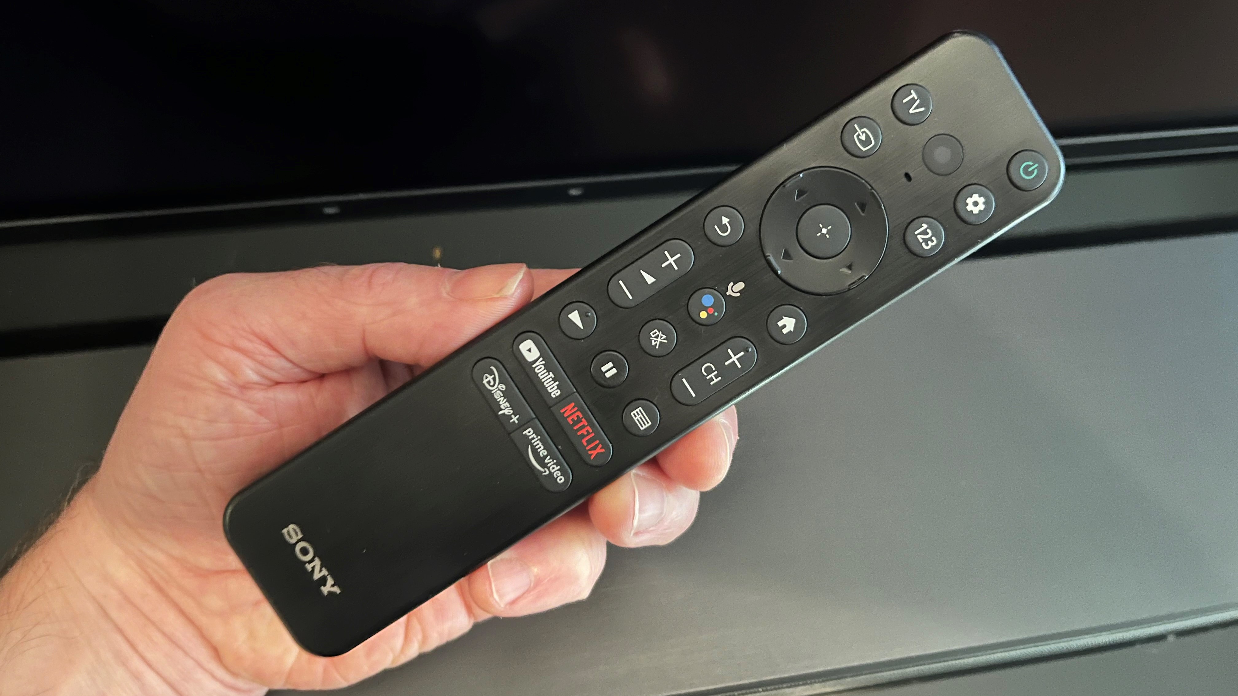 Sony XR A80K OLED remote control in user's hand