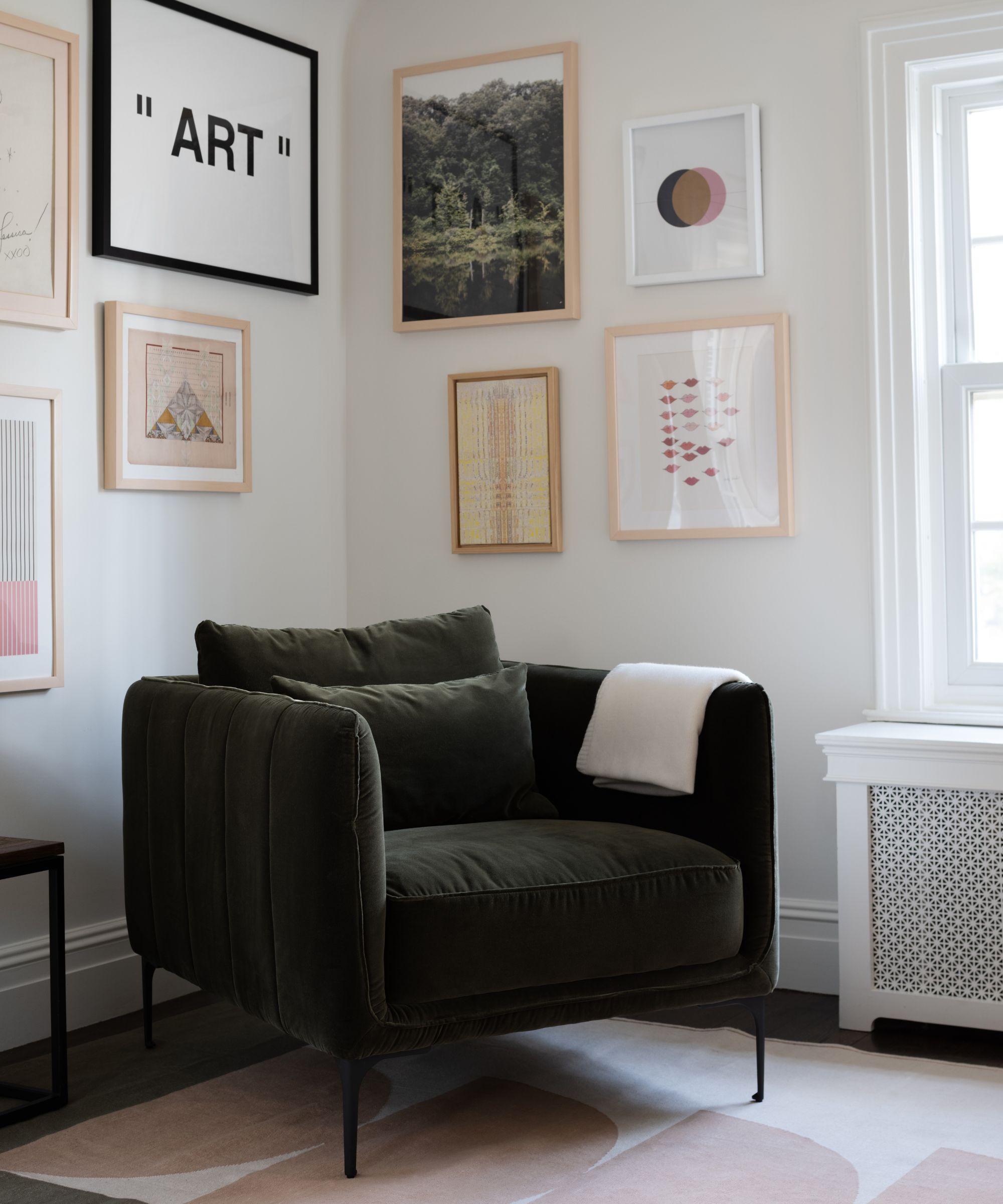 Reading nook with comfortable chair and gallery wall behind