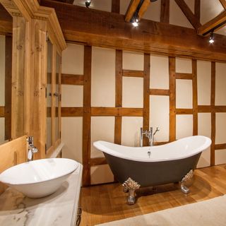 bathroom with wooden beam and wooden flooring