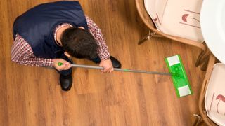 man mopping laminate floor