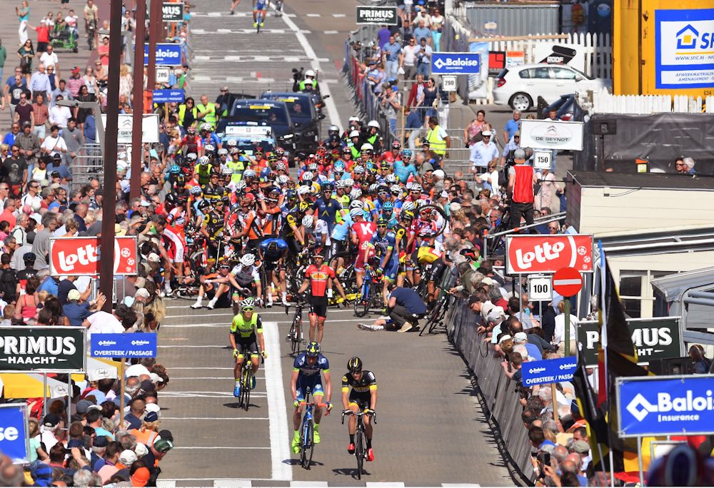 Riders regroup after a big crash at the end of stage 1 at the Belgium Tour