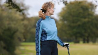 A golfer wears the Ping Zenya Long-Sleeve Top
