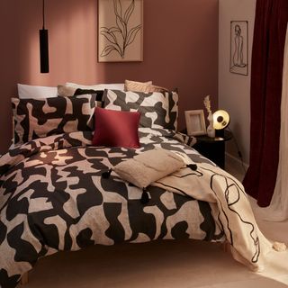 Pink bedroom with black and white bedding