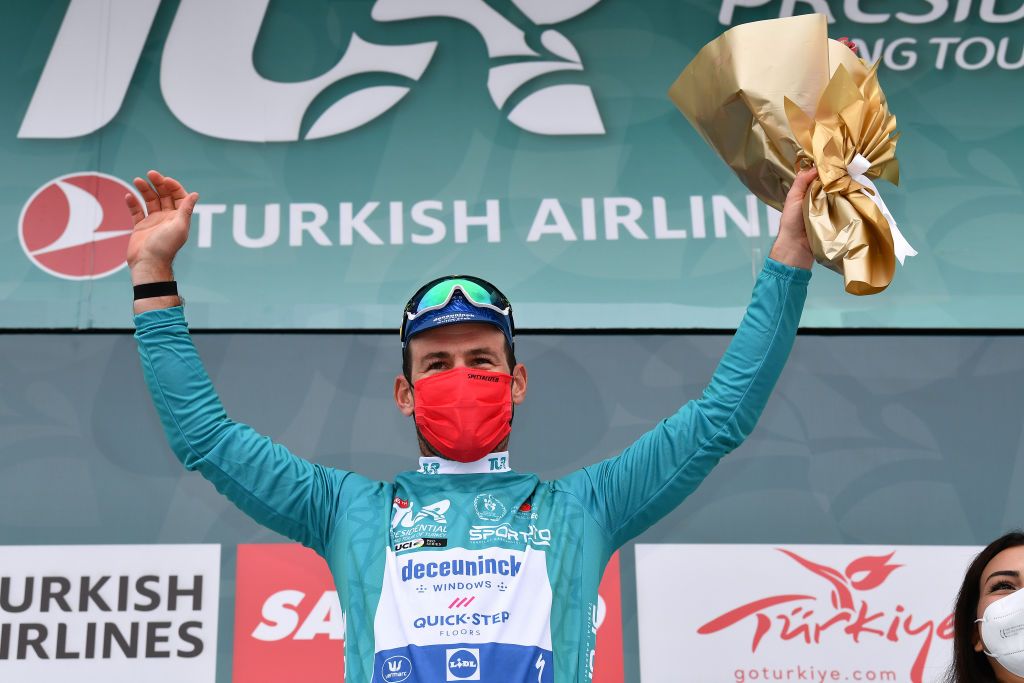 KEMER TURKEY APRIL 14 Podium Mark Cavendish of United Kingdom and Team Deceuninck QuickStep Turquoise Leader Jersey Celebration during the 56th Presidential Cycling Tour Of Turkey 2021 Stage 4 a 1844km stage from Alanya to Kemer Mask Covid safety measures Flowers TUR2021 tourofturkeyTUR on April 14 2021 in Kemer Turkey Photo by Stuart FranklinGetty Images
