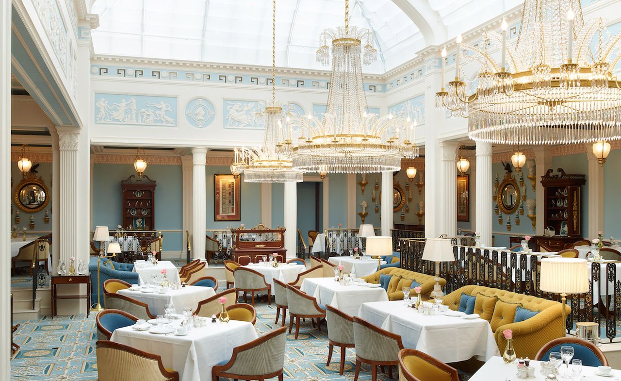 Dining area featuring glass domed ceiling with three chandeliers