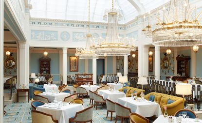 Dining area featuring glass domed ceiling with three chandeliers