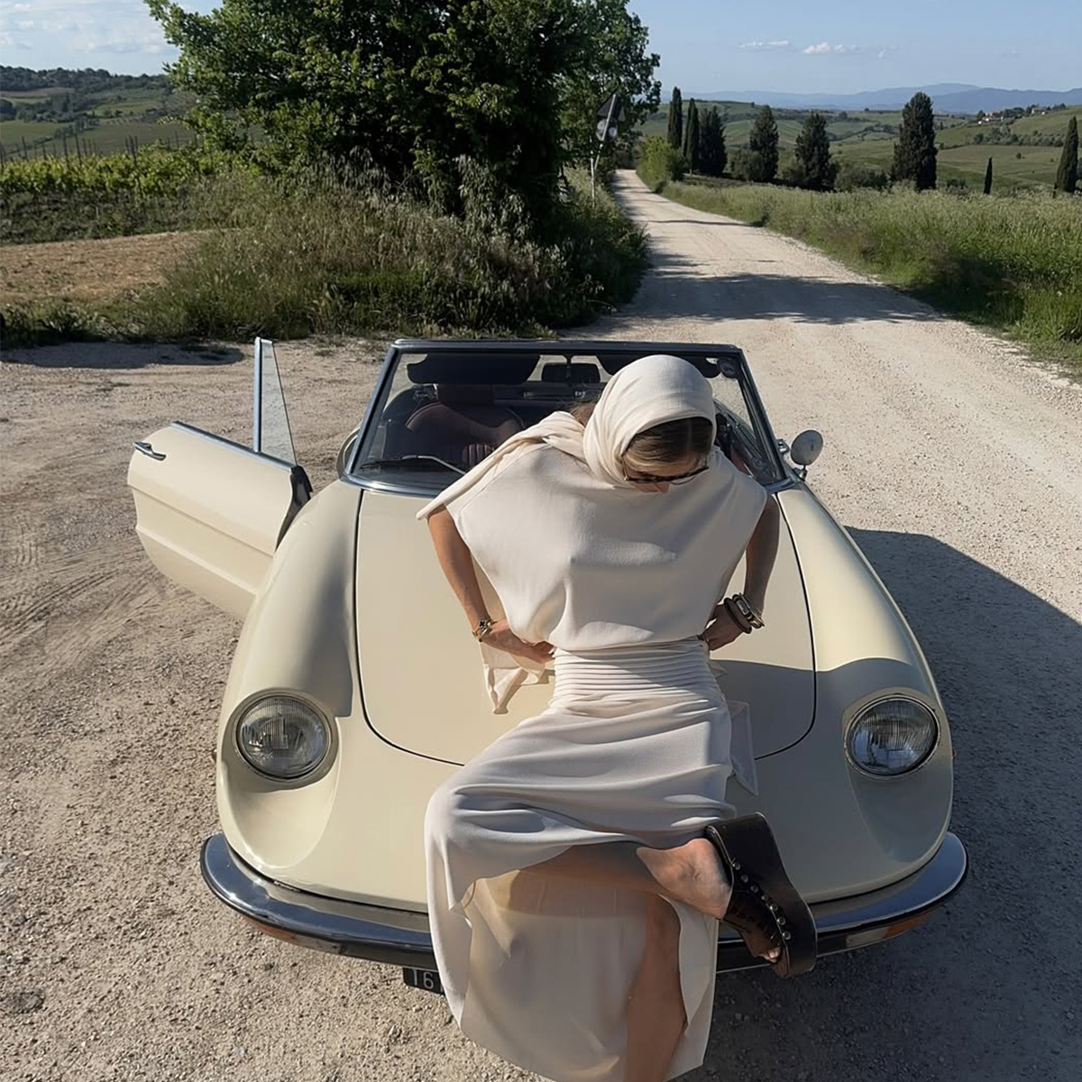 @hannaschonberg wearing an ivory dress in Europe
