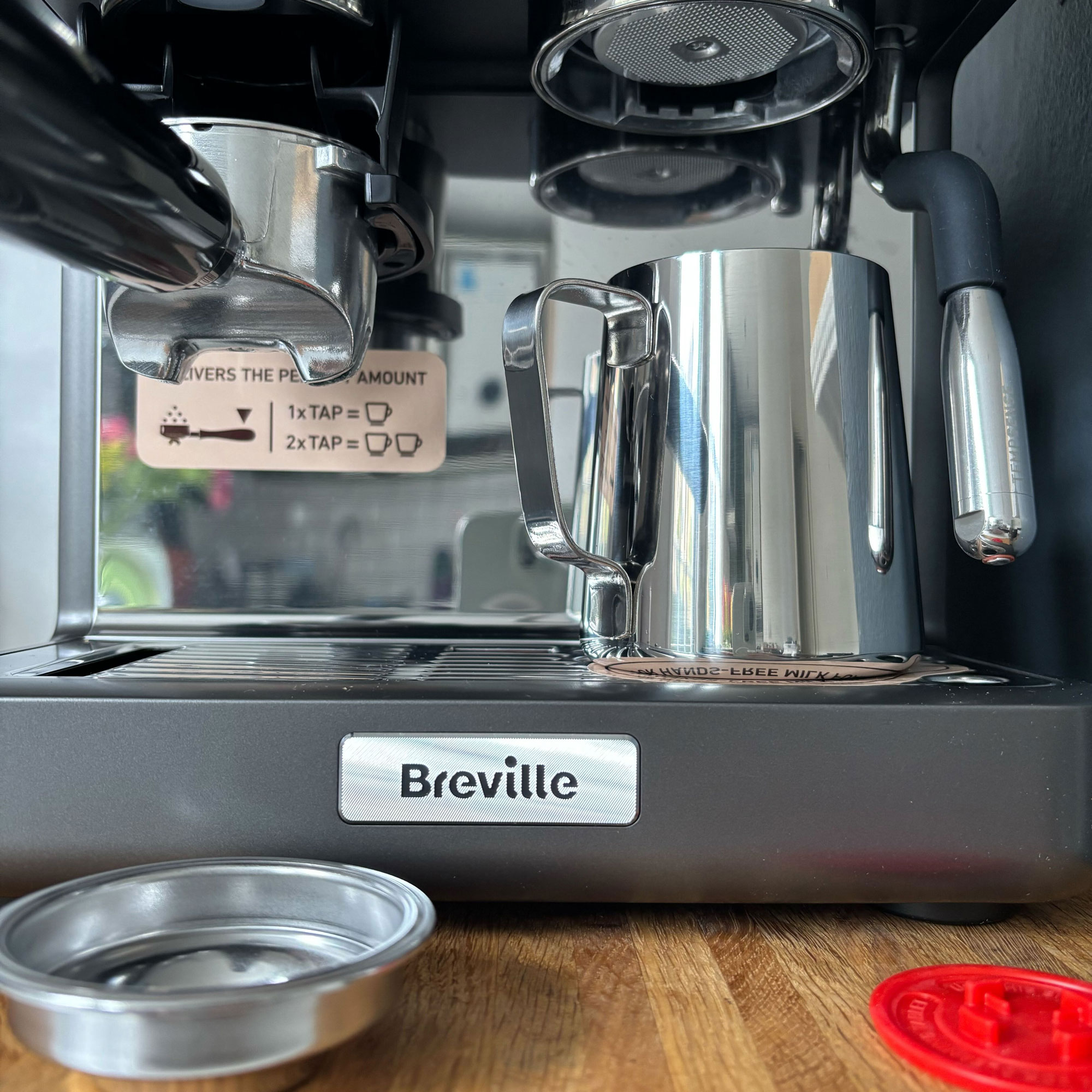 Coffee machine with a view of the portafilter and milk wand