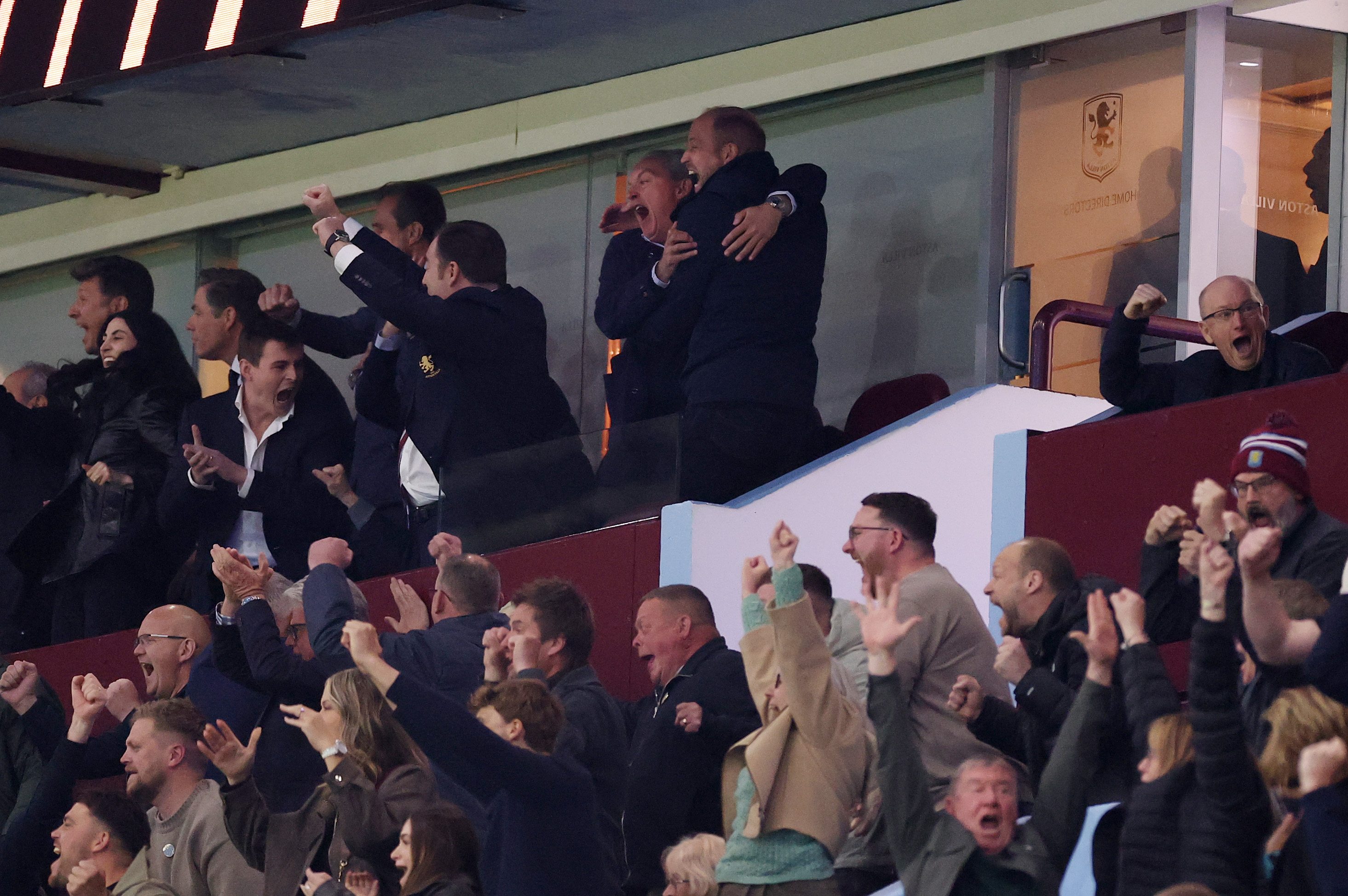 Prince William hugging his friend at an Aston Villa match