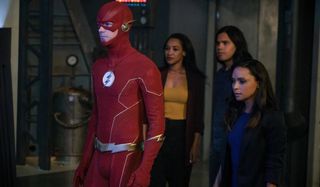 The Flash and his friends stand together in a lab