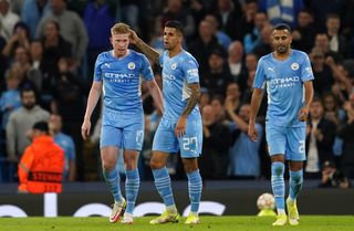 Manchester City’s Kevin De Bruyne (left) celebrates their side’s second goal with team-mate Joao Cancelo after his cross is turned in by RB Leipzig’s Nordi Mukiele for an own goal during the UEFA Champions League, Group A match at the Etihad Stadium, Manchester. Picture date: Wednesday September 15, 2021