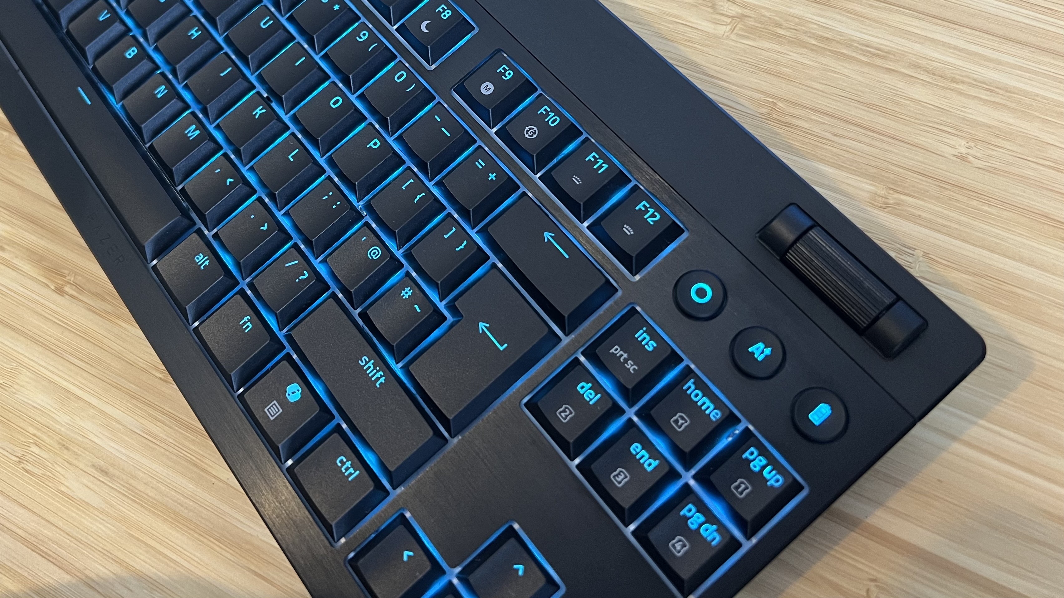 Razer Blackwidow V4 Low Profile controls and keys on a wooden desk