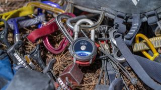 The COROS VERTIX 2S sitting on top of a pile of carabiners.