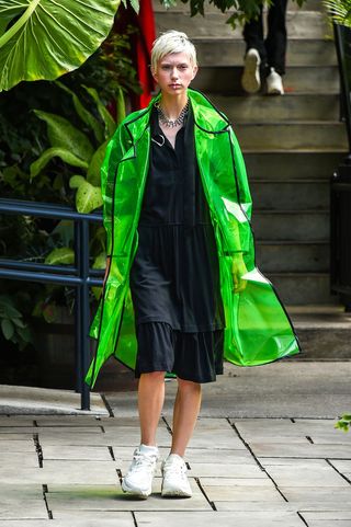 Woman wearing a bright green rain jacket
