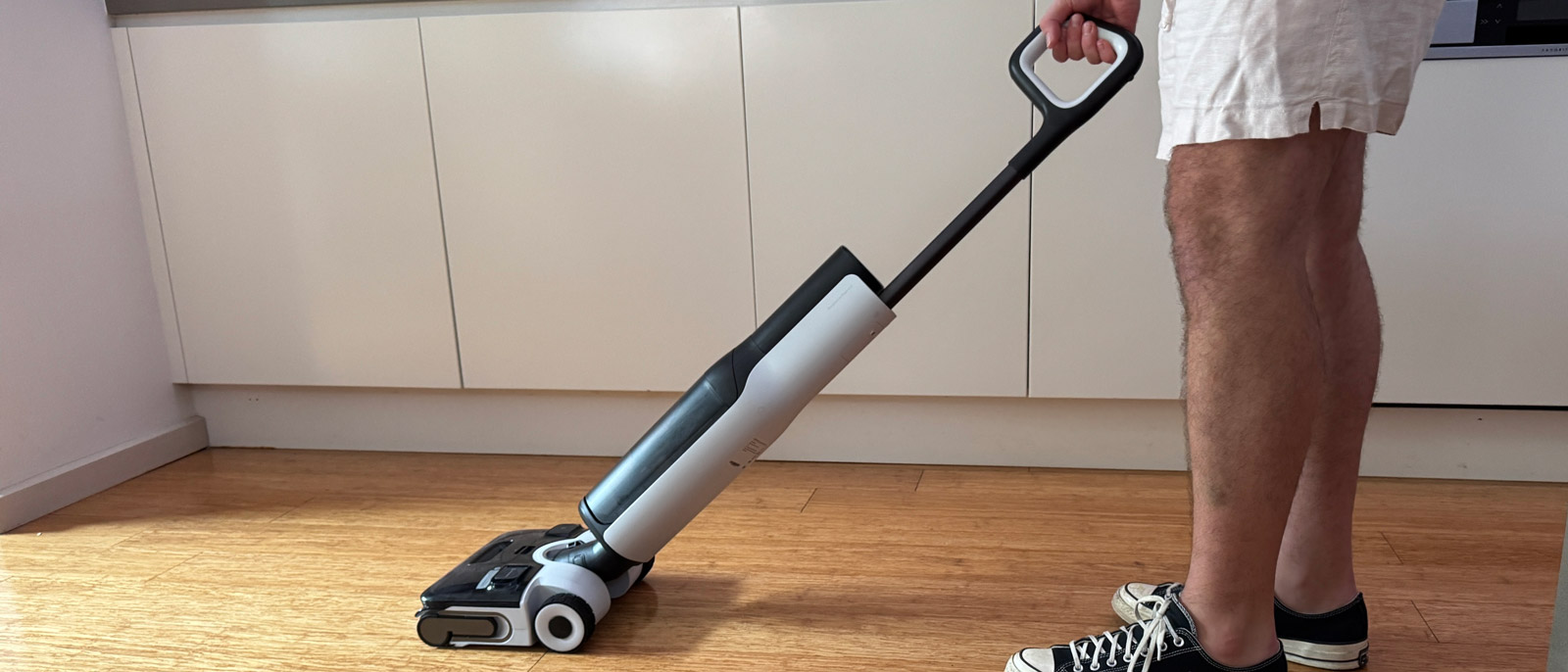 Roborock F25 Ace wet-dry vacuum being used in a kitchen.