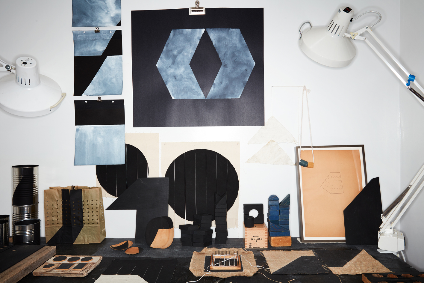 A table in Hass' New York studio table featuring finished works and works in progress