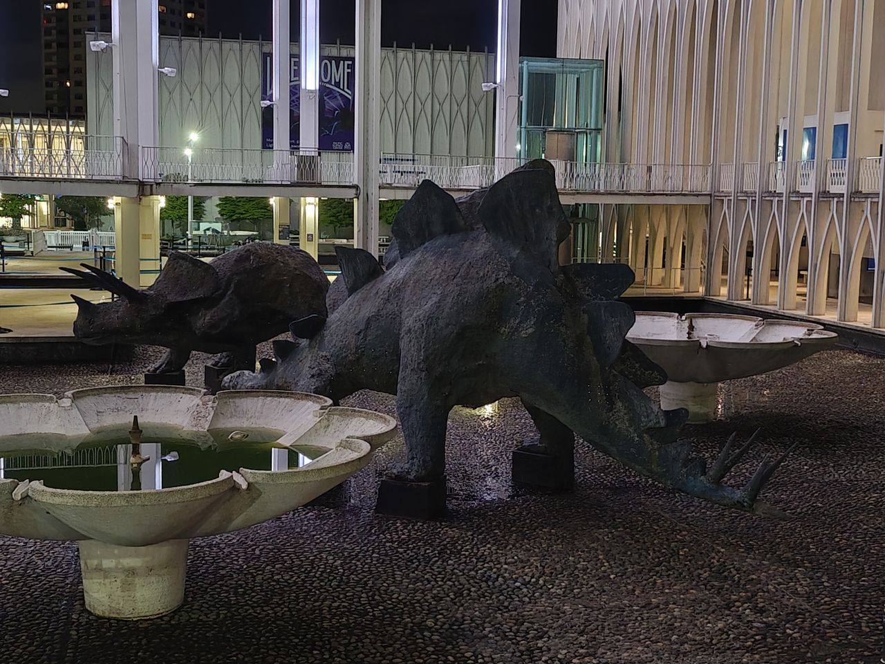 A stone dinosaur sculpture
