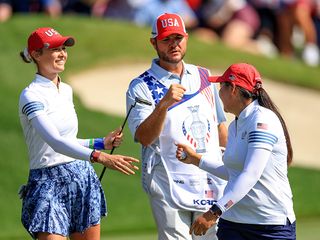 Nelly Korda celebrating with her partner after winning their match on the 14th hole at the Solheim Cup