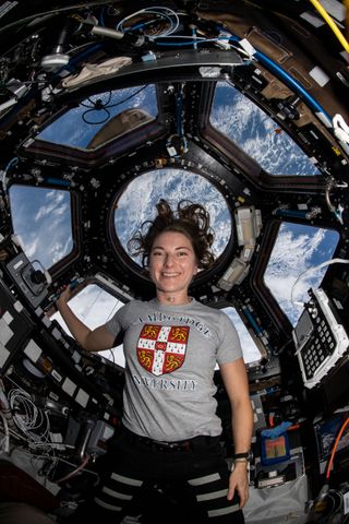 NASA astronaut Kayla Barron at the seven-windowed cupola that is a "window to the world" on the International Space Station.
