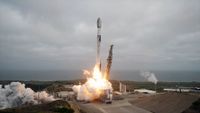 a white and black rocket lifts from a sea-front launch pad into an overcast sky