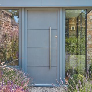 House with aluminium front door with long silver handle.