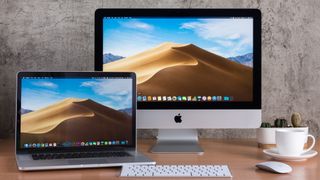 Apple MacBook and Apple iMac on a desk in home office