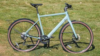 Ride1Up Roadster V3 e-bike parked on grass in the sunshine