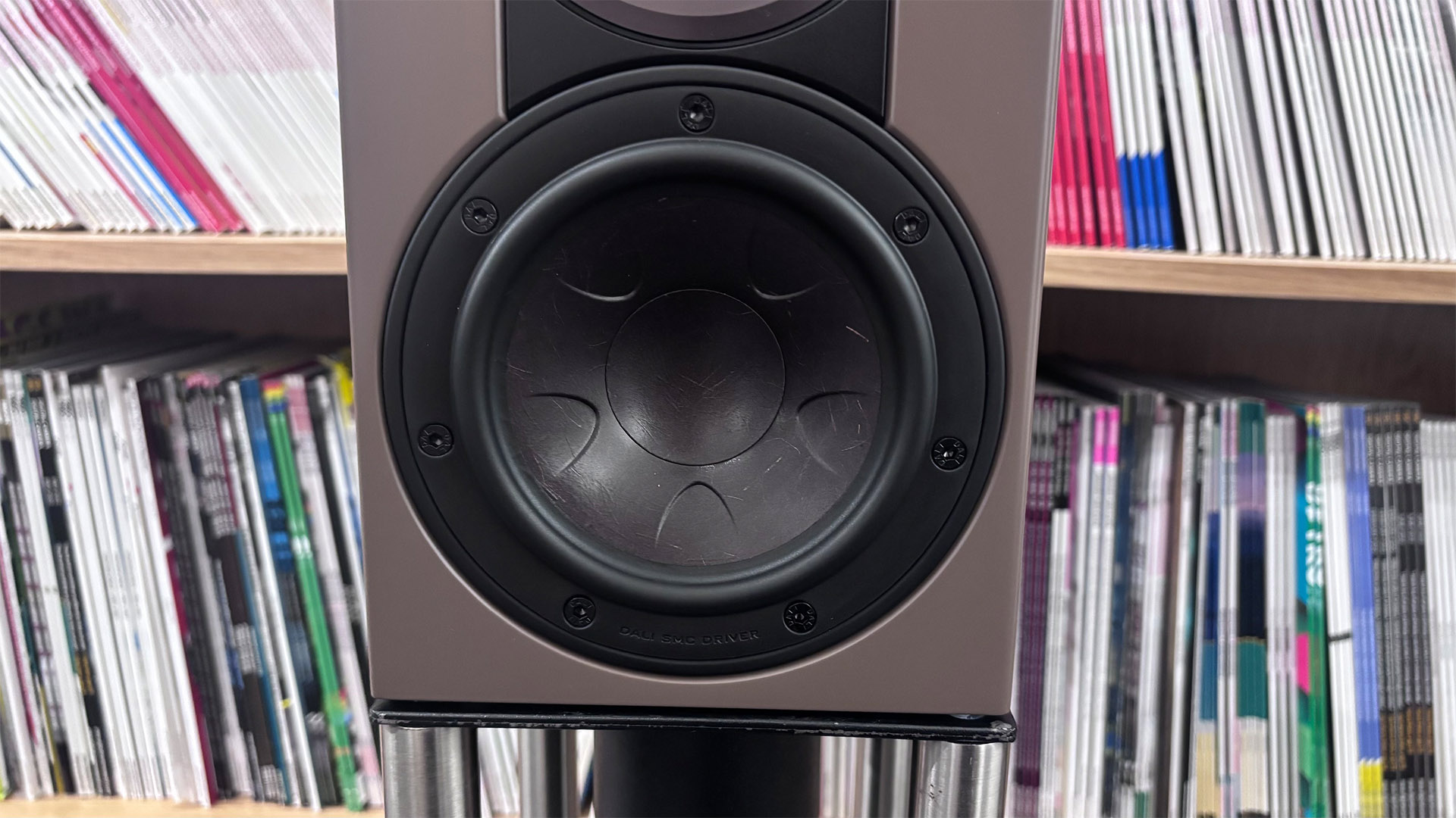 Dali Sonik 1 standmount speakers in front of bookcase, detail of mid/bass unit