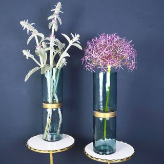 Not On The High Street Sapphire blue glass vases with a band of gold by Miafleur on a white and gold pedestal with a navy background