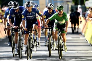 Team Deceuninck Quicksteps Mark Cavendish of Great Britain wearing the best sprinters green jersey crosses the finish line with his teammates at the end of the 11th stage of the 108th edition of the Tour de France cycling race 198 km between Sorgues and Malaucene on July 07 2021 Photo by Philippe LOPEZ AFP Photo by PHILIPPE LOPEZAFP via Getty Images