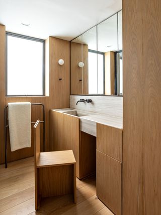 A small bathroom with a pull-out chair