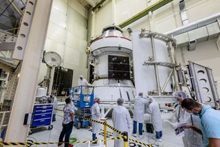NASA's Orion spacecraft is one more step closer to being completed and launched to the moon. Here, three spacecraft jettison fairings are prepared to be installed and secured around the Orion craft. Orion is set to fly as part of the agency's Artemis program and will fly the first woman and the next man to land on the moon.