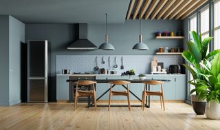 blue kitchen with ceiling timber cladding and dining table