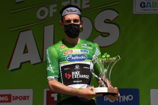 RIVA DEL GARDA ITALY APRIL 23 Simon Yates of United Kingdom and Team BikeExchange Green Leader Jersey celebrates at final podium during the 44th Tour of the Alps 2021 Stage 5 a 1209km stage from Valle del Chiese Idroland to Riva del Garda Trophy Mask Covid Safety Measures TourofTheAlps TouroftheAlps on April 23 2021 in Riva del Garda Italy Photo by Tim de WaeleGetty Images