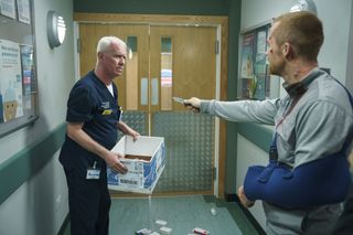 Kyle points a knife at Charlie Fairhead in the ED.