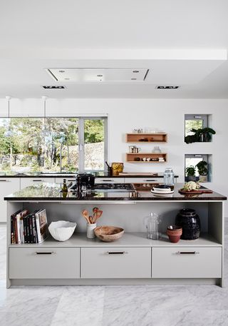 Grey kitchen island with open shelf and lower drawers