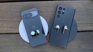 Image showing both pairs of earbuds on top of their respective phones