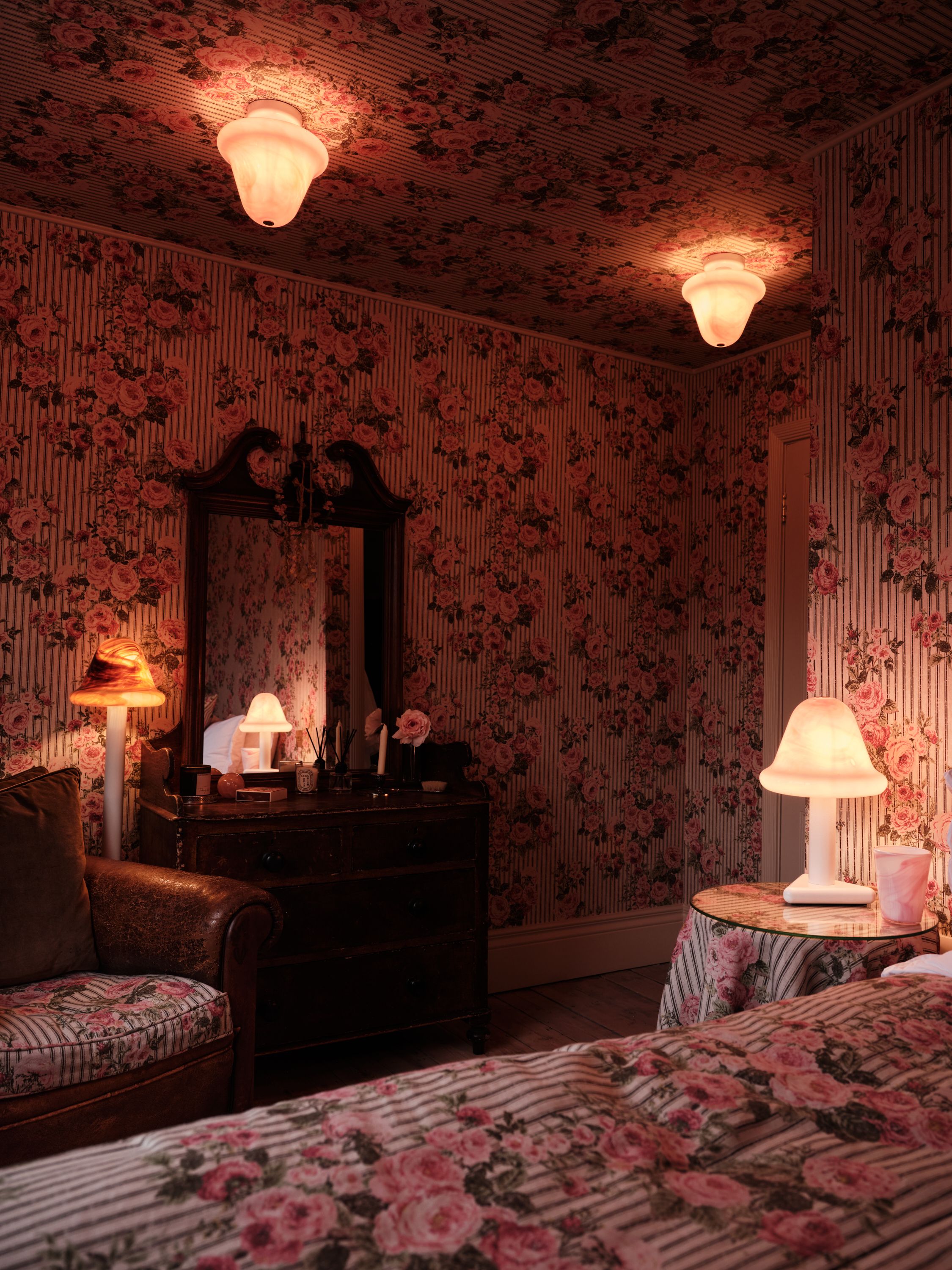 a floral drench room with a series of lamps and ceiling lights made from glass