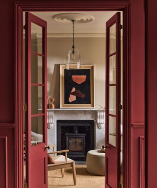 living space through doorway painted burgundy