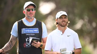 Tommy Fleetwood of England talks with his caddie Ian Finnis on the 16th tee on Day Two of the Hero Dubai Desert Classic at Emirates Golf Club on January 19, 2024 in Dubai, United Arab Emirates.