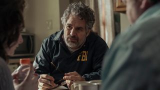 Mark Ruffalo at a table talking with two people in Task