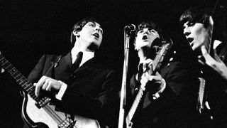 The Beatles performing onstage in 1964