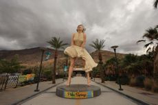 Storm clouds approach a Marilyn Monroe statue in Palm Springs, California.