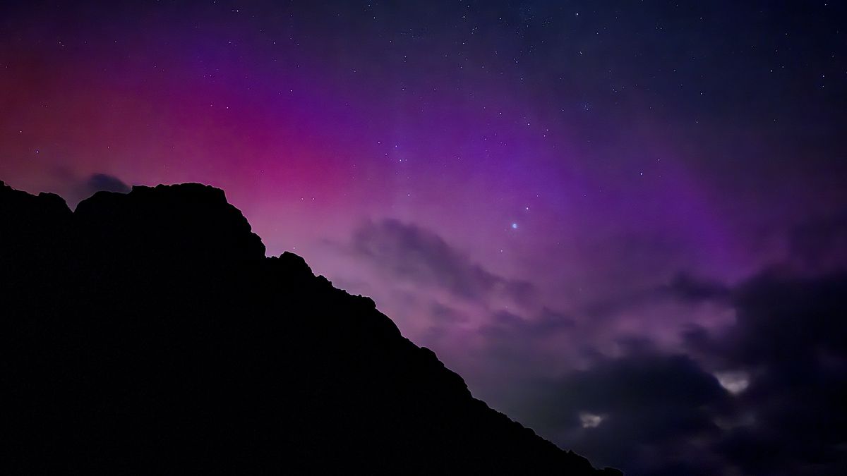 a vivid red and purple sky colored by auroras.