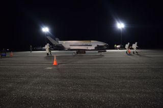 A U.S. Air Force X-37B space plane, an unpiloted miniature space shuttle, is seen after landing at NASA's Kennedy Space Center Shuttle Landing Facility on Oct. 27, 2019 to end its record 780-day OTV-5 mission. 