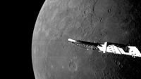 A black and white image of a spacecraft wing in front of a large planet with some craters.