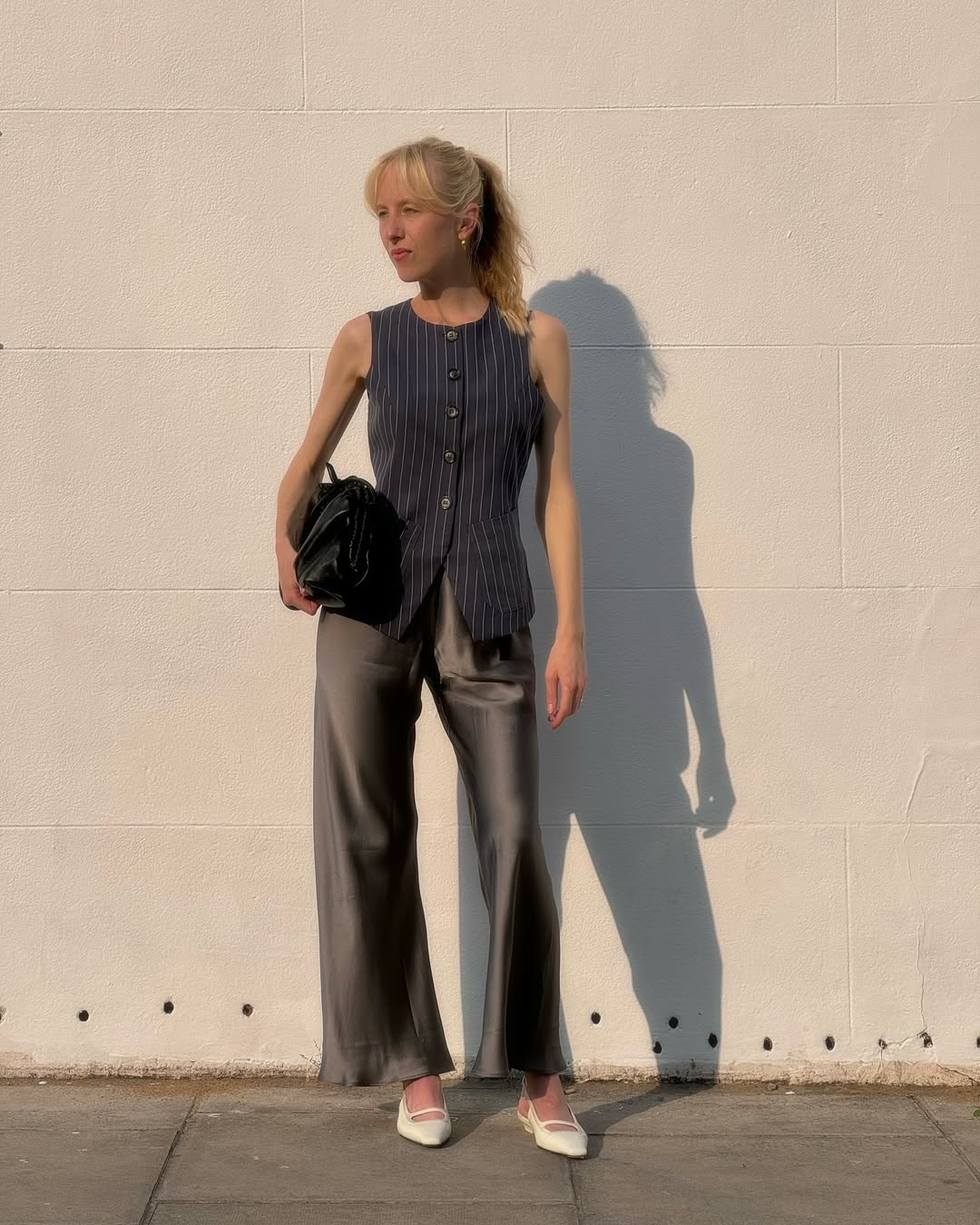 An image of influencer @alicezielasko wearing shoes with satin trousers.